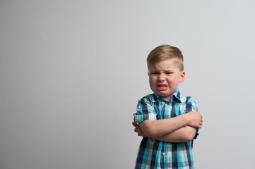Portrait of angry caucasian boy