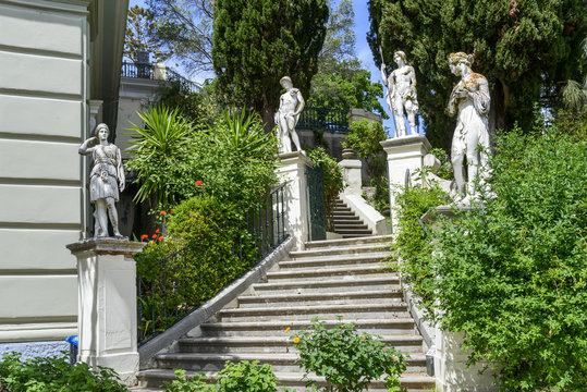 Classical inspired statues on stairs to the Achilleion palace in Gastouri, Corfu island in Greece.