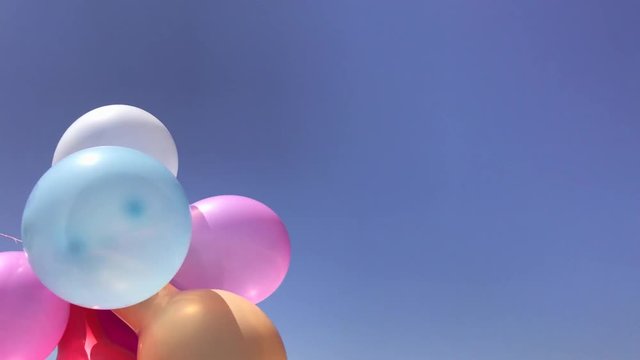 Multicolored balloons against the sky