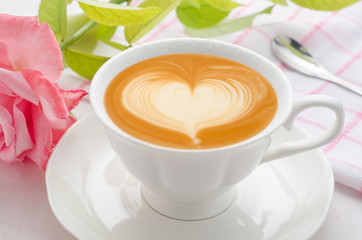 Cup of coffee latte art top view on white wooden background