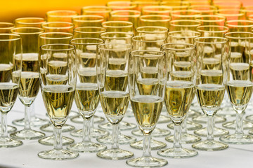 Many glasses of champagne on white table