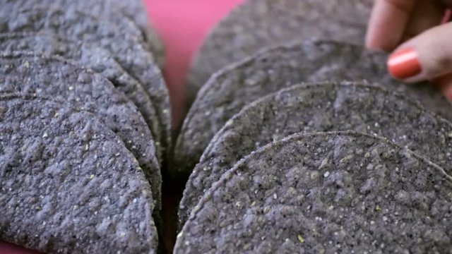 Blue corn taco shells on a pink background