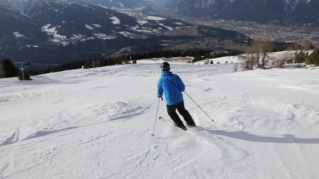 slow motion of downhill skiing, skier going fast down the mountain