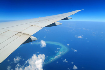 Maldives islands top view and airplane wing