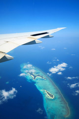 Naklejka premium Maldives islands top view and airplane wing