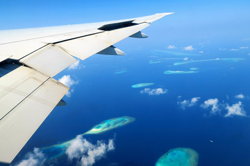 Naklejka na ściany i meble Maldives islands top view and airplane wing