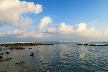 Local surfing spot on Himmafushi island, Maldives: clouds reflection in ocean