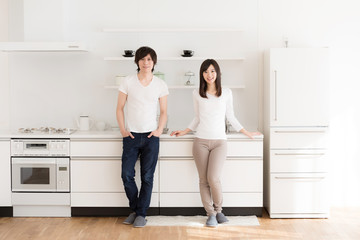 young asian couple relaxing in kitchen