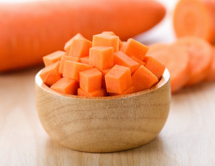 carrot slices in wood bowl
