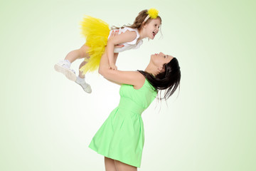 Happy mother holding a young daughter.