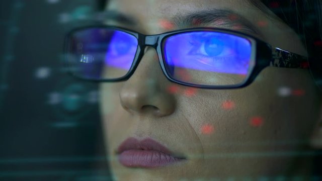 The businesswoman with a glasses look to the virtual display