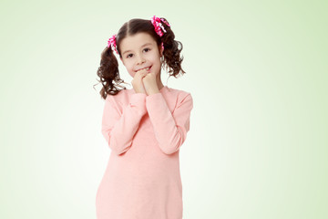 Shy girl holding hands near the face.