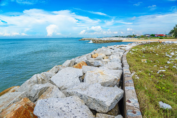 Stone wave breaker into the sea