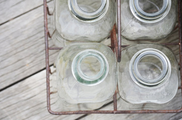 Antique glass milk bottles in metal crate