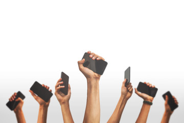 group of people's hands holding phones and rising them up against a white backgroud