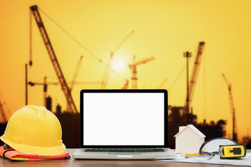 Close up of laptop on workplace for construction worker on building construction background