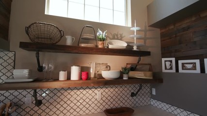 Lowering Modern Kitchen Corner with Lens Flare. rising shot in the corner of a modern rustic industrial kitchen, reclaimed wood and high ceilings with sun flare through window
