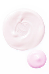 Light pink cosmetics products on white