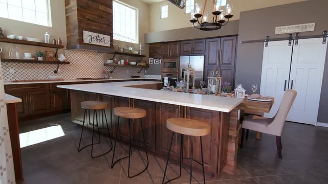 Rising on Modern Kitchen Island with Stools. a loft style rustic industrial kitchen rises to reveal high ceilings
