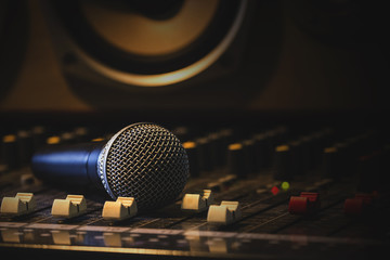 Microphone with audio equipment in the studio.