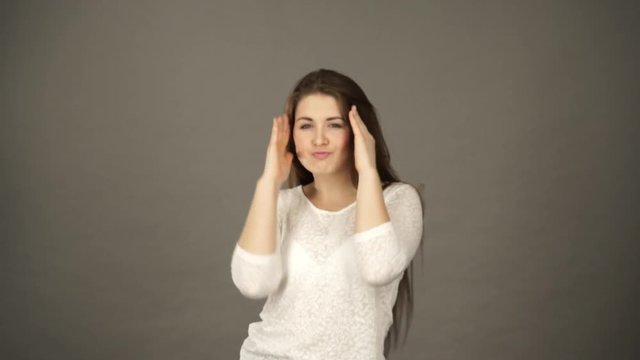 Woman having fun dancing, joyful young female showing positive expression, studio shot grey wall background 4