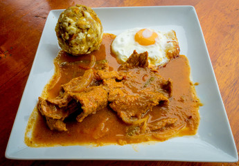 Bolon de verde with fried eggs and meat stew ecuadorian food galapagos