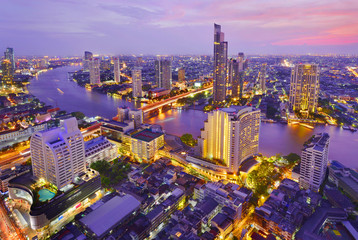Bangkok river view at Dusk with modern business building along the Chao Phraya river ,Thailand