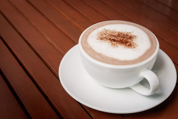 cup of hot chocolate on wooden table background