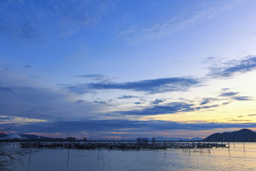 Fototapeta na wymiar View of Sonkhla lake which has fish cage (sea bass) in water at sunset ; Sonkhla province, Thailand