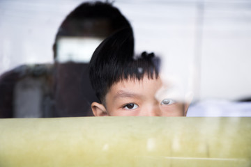 boy hide himself behind sofa in the mirror room