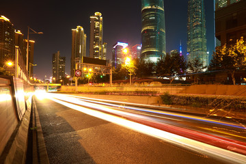 Fototapeta na wymiar Empty road surface with city landmark buildings of night