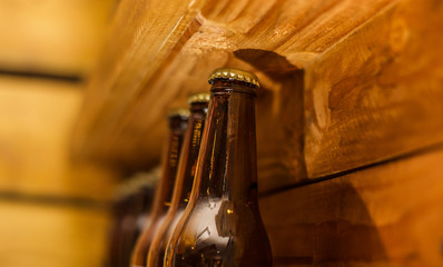 Naklejka premium Close up of bottles of craft beer on wooden background