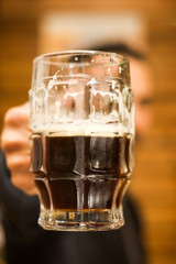 Close up of a man dolding a dark beer, delicious craft beer Booze Brew Alcohol Celebrate