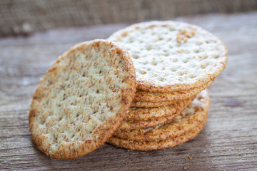 Round shape crackers on wooden texture and bakcground