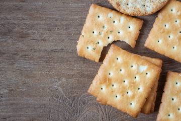 Crackers or biscuit on wooden background, top view