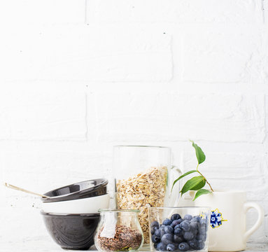 Kitchen tools, olive cutting board on a kitchen shelf against a white brick wall. selective focus