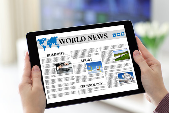 Female hands holding tablet with app world news on screen