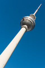 Fototapeta premium The Television Tower in Berlin in front of a blue sky