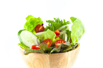 vegetables salad in a wooden bowl isolated on white