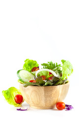 vegetables salad in a wooden bowl isolated on white