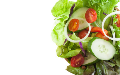 close up view of vegetables salad in a wooden bowl isolated on white, top view