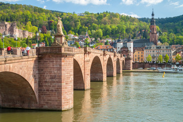 The Church of Holy spirit and Carl Theodor Old Bridge located next to Neckar river in Heidelberg, Germany. - obrazy, fototapety, plakaty