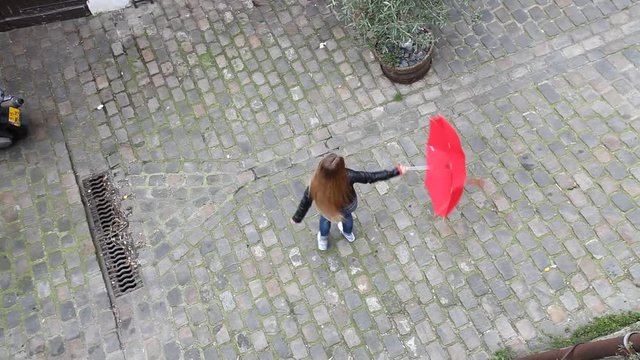 top view of young happy carefree woman turning around with red umbrella on the street, enjoying life concept background