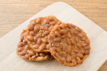 Three Thai Peanut Cracker on A Wooden Board
