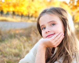 Autumn portrait smiling adorable little girl in the park