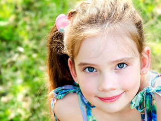 Portrait of adorable smiling little girl outdoor