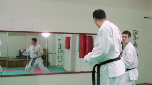kTwo karate players compete in the ring 4k