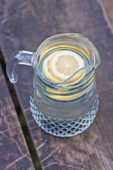 Birch juice with a slice of lemon in a jar. Hot weather. Thirst quenching. Country style. Rustic style
