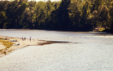  Germany,Isar river near Munich  in summer, people enjoying the sun on the banks