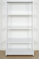 white metal rack near the wall, empty shelves